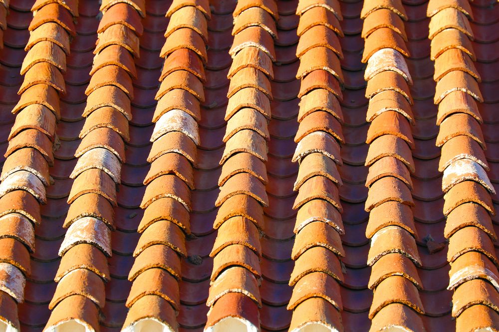 Stock photograph showing sunlit interlocking roof tiles